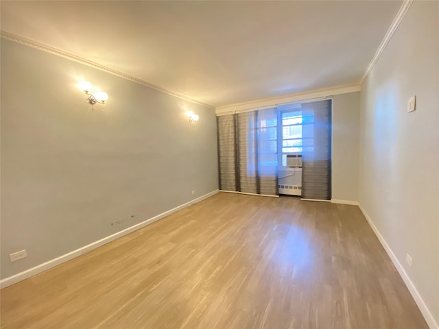 unfurnished room with ornamental molding and light hardwood / wood-style flooring