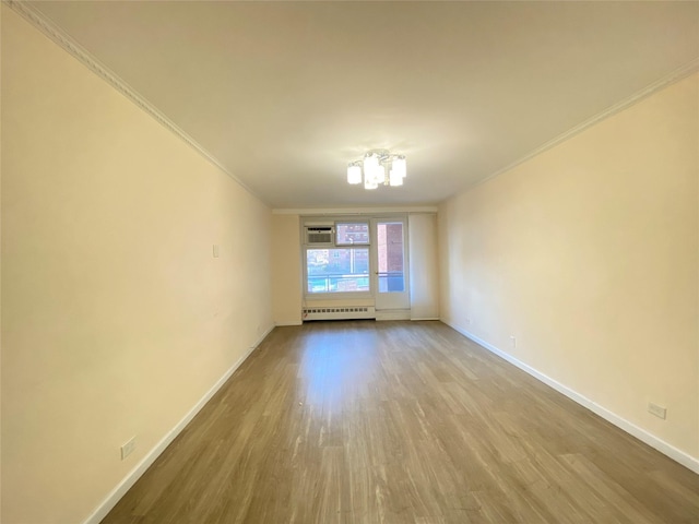 unfurnished room with radiator, light hardwood / wood-style flooring, and ornamental molding