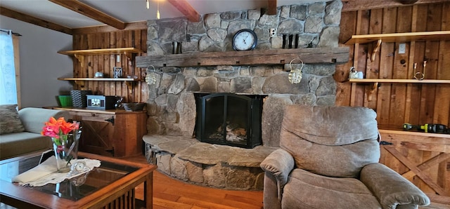 living room with hardwood / wood-style floors, a fireplace, and beamed ceiling