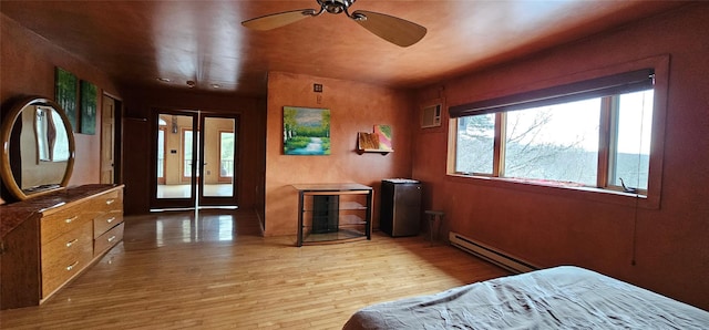 bedroom featuring light wood-type flooring and baseboard heating