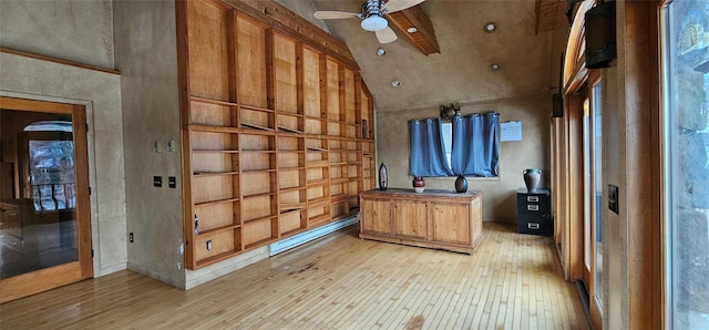 interior space featuring high vaulted ceiling, a baseboard heating unit, ceiling fan, and light hardwood / wood-style flooring