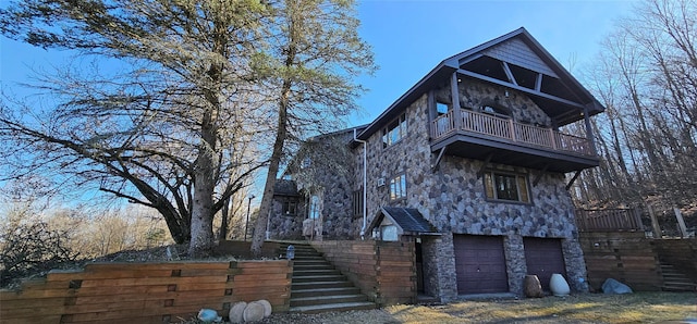 581 Hessinger Lare Rd, Jeffersonville, NY 12748 - view of front of home featuring stone siding, a balcony, stairs, a garage, and driveway
