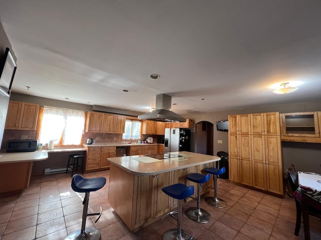 581 Hessinger Lare Rd, Jeffersonville, NY 12748 - kitchen with island exhaust hood, stainless steel appliances, arched walkways, tasteful backsplash, and recessed lighting