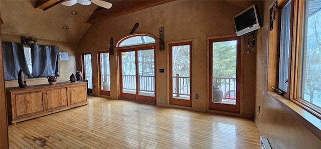 581 Hessinger Lare Rd, Jeffersonville, NY 12748 - unfurnished living room featuring a ceiling fan, light wood finished floors, beam ceiling, and high vaulted ceiling