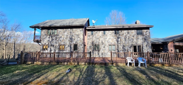 581 Hessinger Lare Rd, Jeffersonville, NY 12748 - back of house with stone siding, a yard, a chimney, a balcony, and a wooden deck