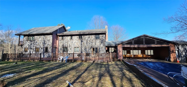 581 Hessinger Lare Rd, Jeffersonville, NY 12748 - rear view of house with stone siding, a yard, and a deck