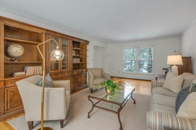 living room with crown molding and light wood-type flooring