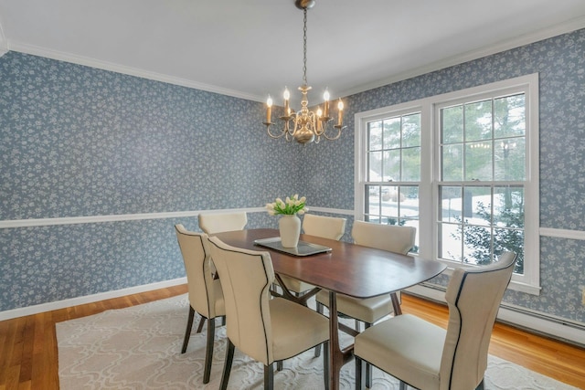 dining room with hardwood / wood-style flooring, crown molding, and a chandelier