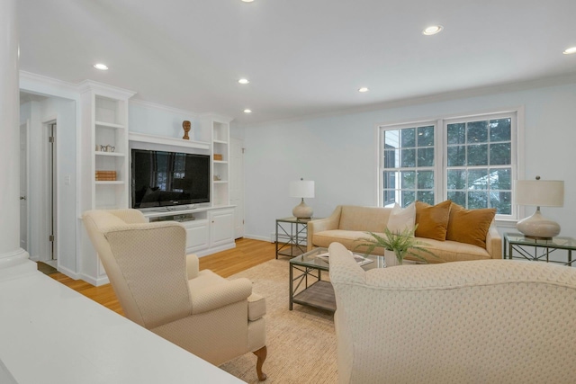 living room with crown molding, a baseboard radiator, and light hardwood / wood-style floors