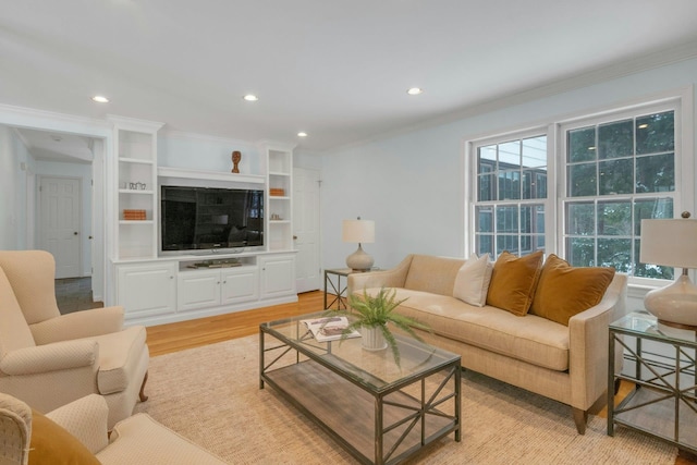 living room featuring ornamental molding and light hardwood / wood-style floors