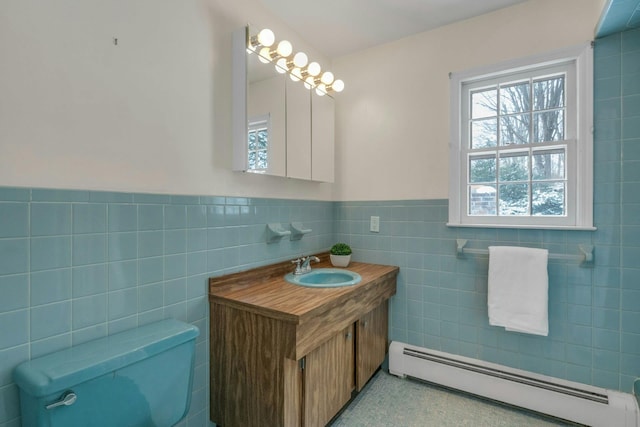 bathroom featuring a baseboard radiator, vanity, toilet, and tile walls