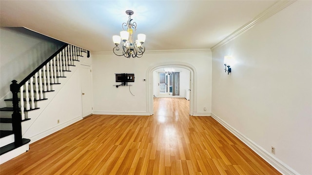 interior space with hardwood / wood-style floors, a notable chandelier, and ornamental molding