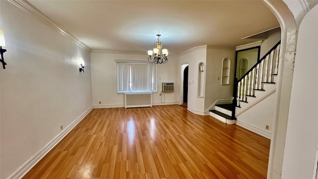 interior space featuring radiator, crown molding, a wall mounted air conditioner, wood-type flooring, and a chandelier