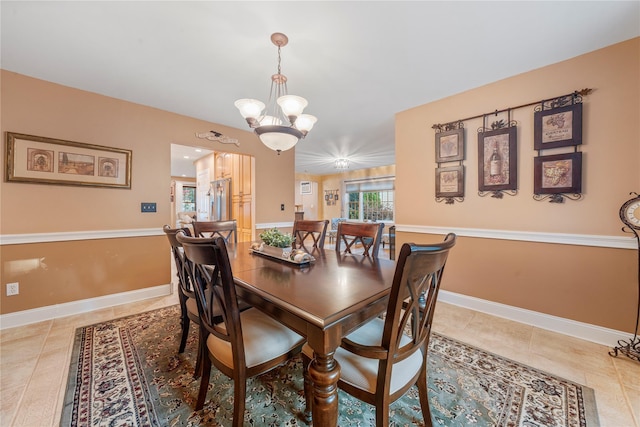 dining room with light tile patterned flooring and a chandelier