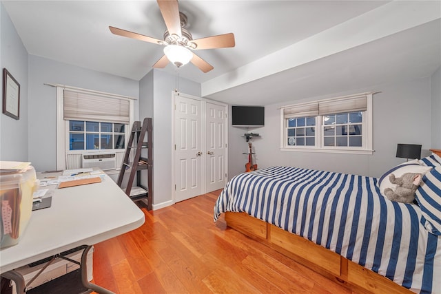 bedroom with ceiling fan, light wood-type flooring, and a closet