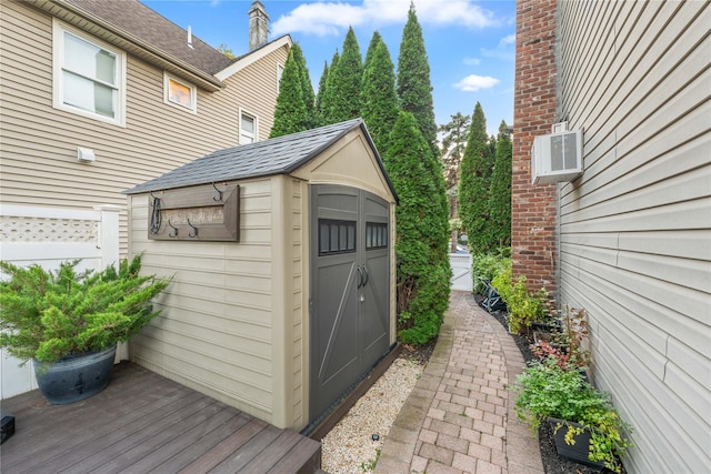 view of outdoor structure featuring a wall unit AC