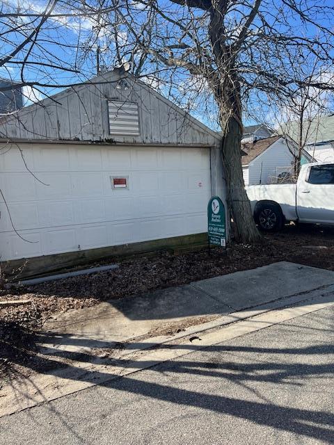 view of property exterior with an outbuilding and a garage
