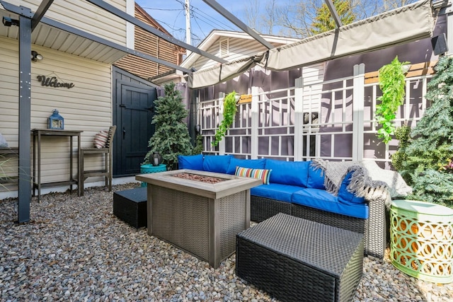 view of patio featuring an outdoor living space with a fire pit and a sunroom