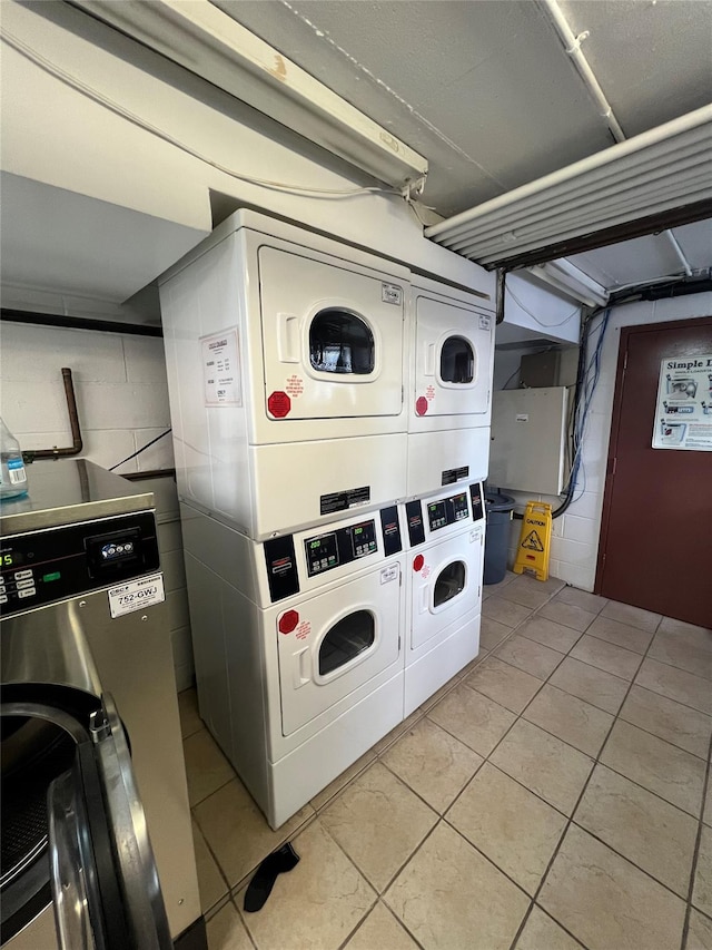 washroom with light tile patterned flooring, stacked washer and clothes dryer, and separate washer and dryer