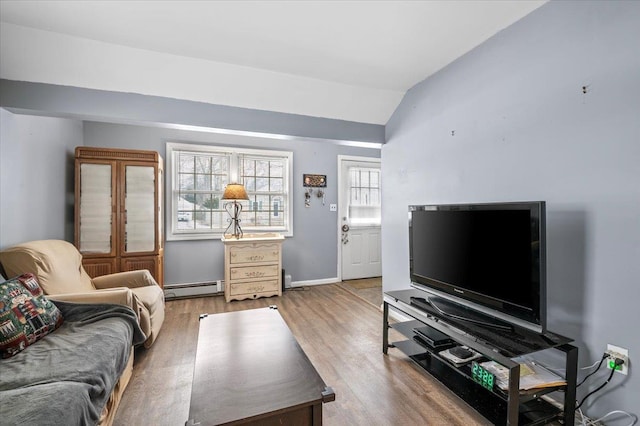 living room featuring wood-type flooring, vaulted ceiling, and a baseboard radiator