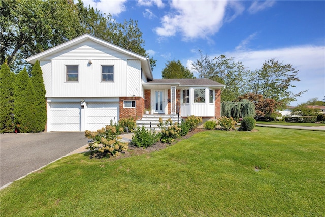 split level home featuring a garage and a front lawn