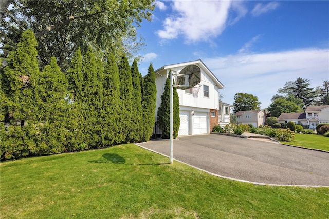 view of home's exterior featuring a yard and a garage