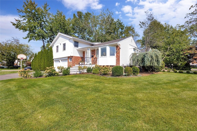 tri-level home with a garage and a front yard