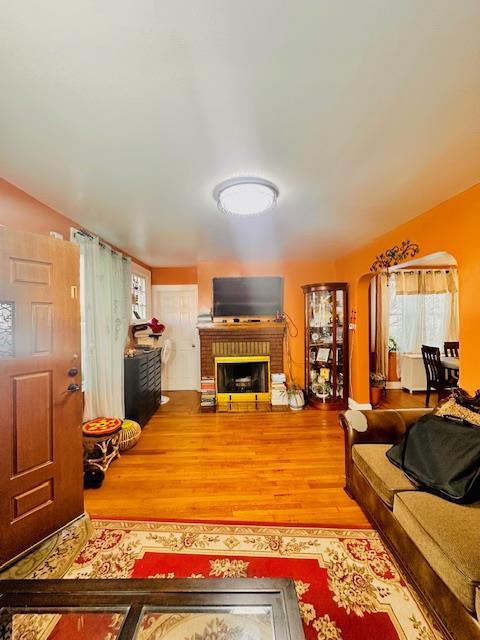 living room with hardwood / wood-style floors and a fireplace