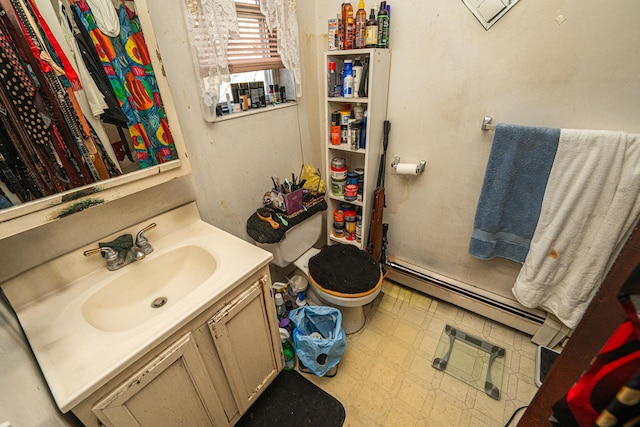 bathroom featuring a baseboard radiator, vanity, and toilet