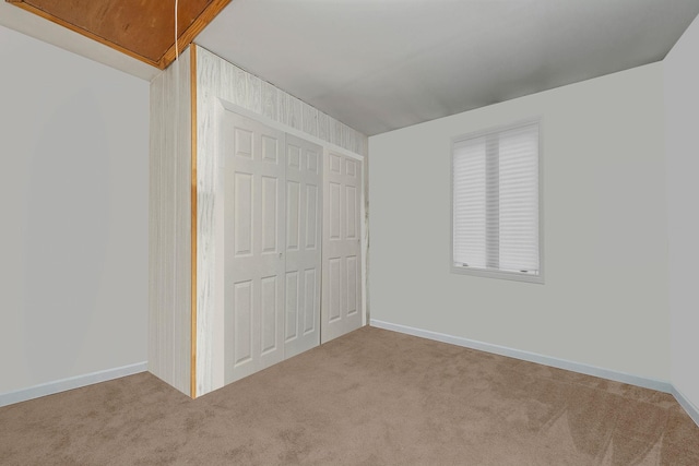 unfurnished bedroom featuring carpet flooring and a closet