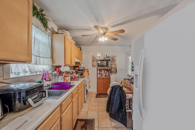 kitchen featuring ceiling fan, a healthy amount of sunlight, light tile patterned floors, and light brown cabinets