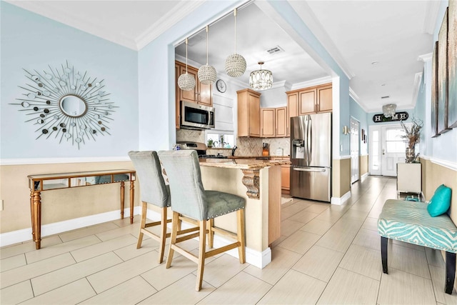 192 Bch 74th St, Arverne, NY 11692 - kitchen featuring appliances with stainless steel finishes, a breakfast bar, light stone counters, backsplash, and ornamental molding