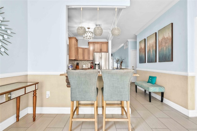 192 Bch 74th St, Arverne, NY 11692 - dining room featuring a chandelier, ornamental molding, and baseboards