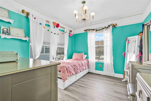 192 Bch 74th St, Arverne, NY 11692 - bedroom with a chandelier, light wood-style flooring, and baseboards