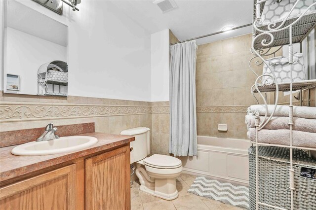 192 Bch 74th St, Arverne, NY 11692 - bathroom with toilet, tile patterned flooring, vanity, shower / bath combo with shower curtain, and wainscoting