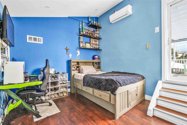 192 Bch 74th St, Arverne, NY 11692 - bedroom with an AC wall unit and wood finished floors