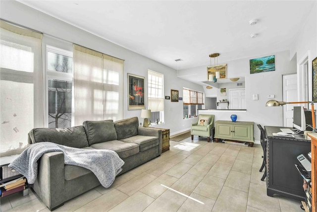 192 Bch 74th St, Arverne, NY 11692 - living room featuring light tile patterned floors and baseboards