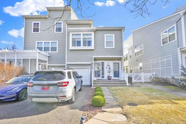192 Bch 74th St, Arverne, NY 11692 - view of front of home featuring a garage, asphalt driveway, and fence