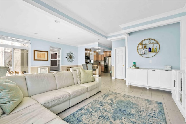 192 Bch 74th St, Arverne, NY 11692 - living area featuring a chandelier, crown molding, light tile patterned floors, and a wainscoted wall