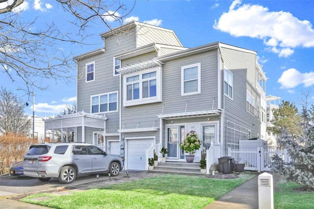 192 Bch 74th St, Arverne, NY 11692 - multi unit property featuring an attached garage, driveway, and a gate