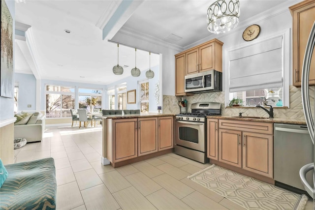 192 Bch 74th St, Arverne, NY 11692 - kitchen with appliances with stainless steel finishes, open floor plan, a peninsula, tasteful backsplash, and ornamental molding