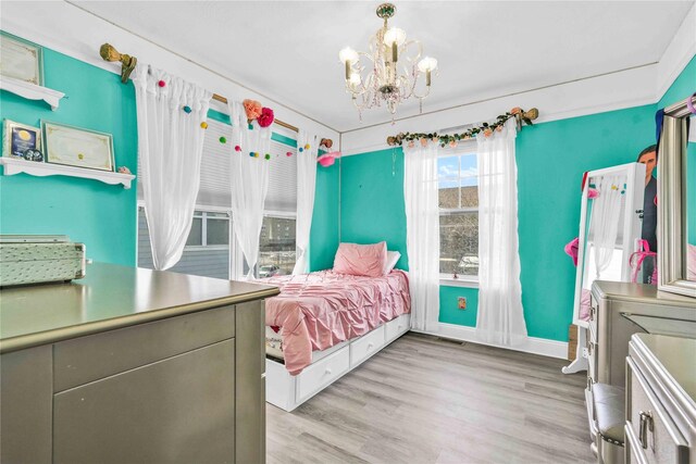 192 Bch 74th St, Arverne, NY 11692 - bedroom featuring a chandelier and light wood finished floors