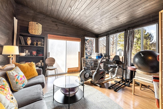 living room featuring vaulted ceiling, wood ceiling, and a healthy amount of sunlight