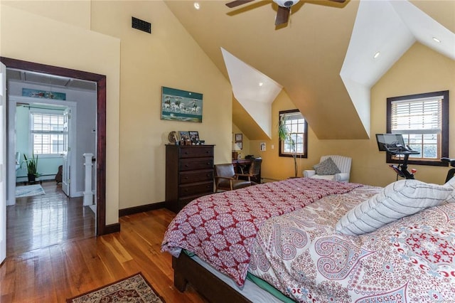 bedroom featuring high vaulted ceiling, baseboards, and wood finished floors