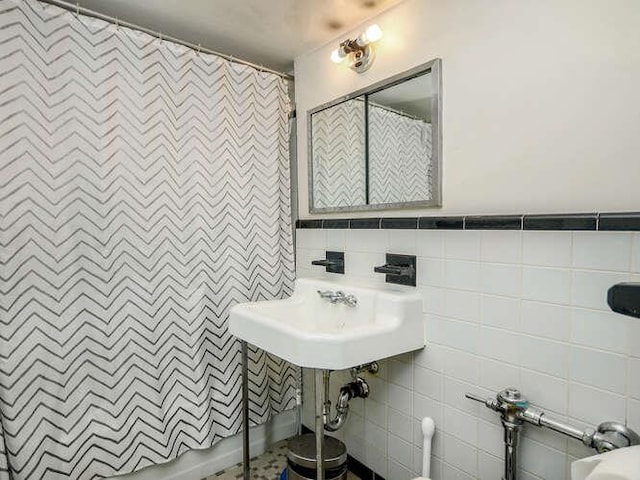 bathroom with tile walls