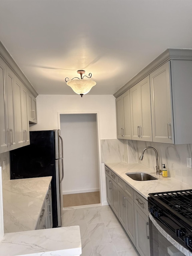 138-10 Franklin Ave Unit 3L, Flushing, NY 11355 - kitchen featuring gray cabinets, freestanding refrigerator, black range, light marble finish floors, and light stone countertops