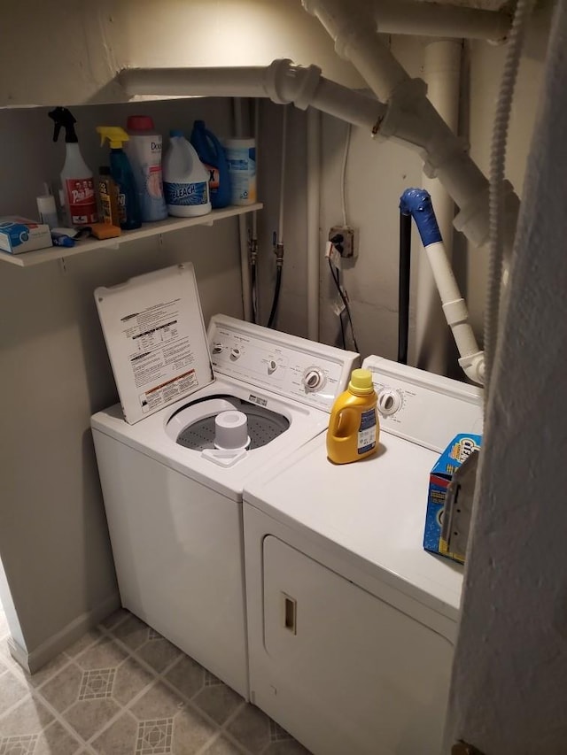 clothes washing area with washer and clothes dryer