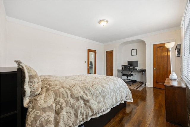 bedroom featuring crown molding and dark hardwood / wood-style flooring