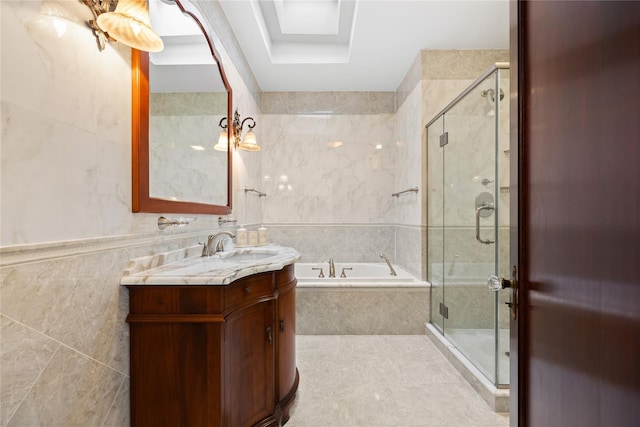 bathroom with tile walls, vanity, and separate shower and tub