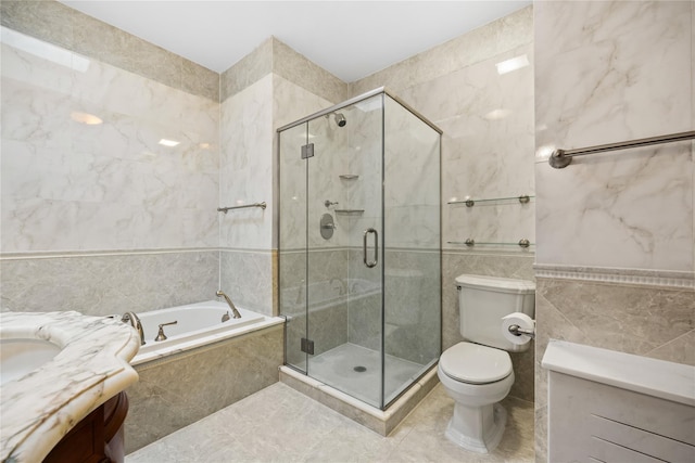 full bathroom featuring vanity, separate shower and tub, tile walls, and toilet